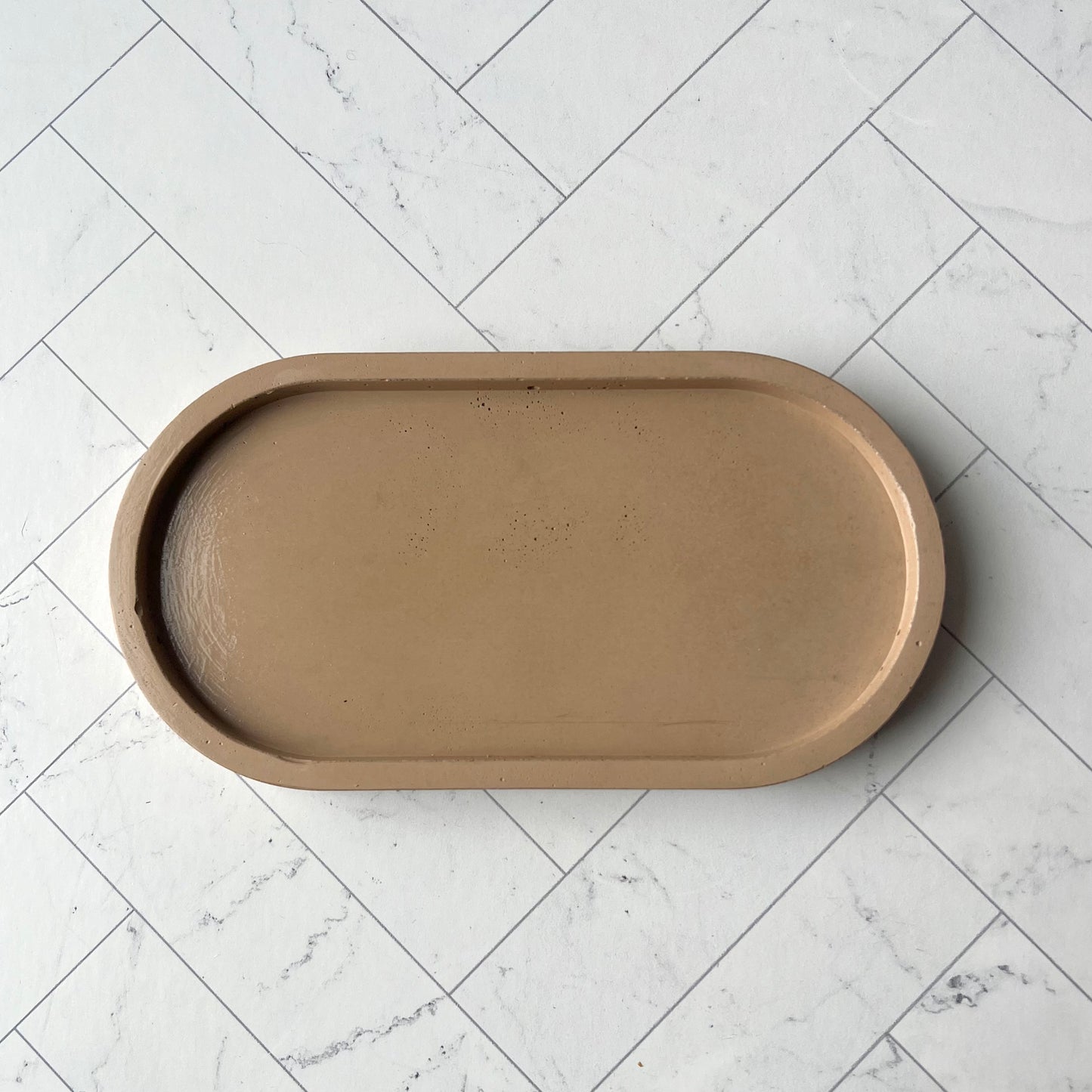 A light brown oval tray shown from overhead