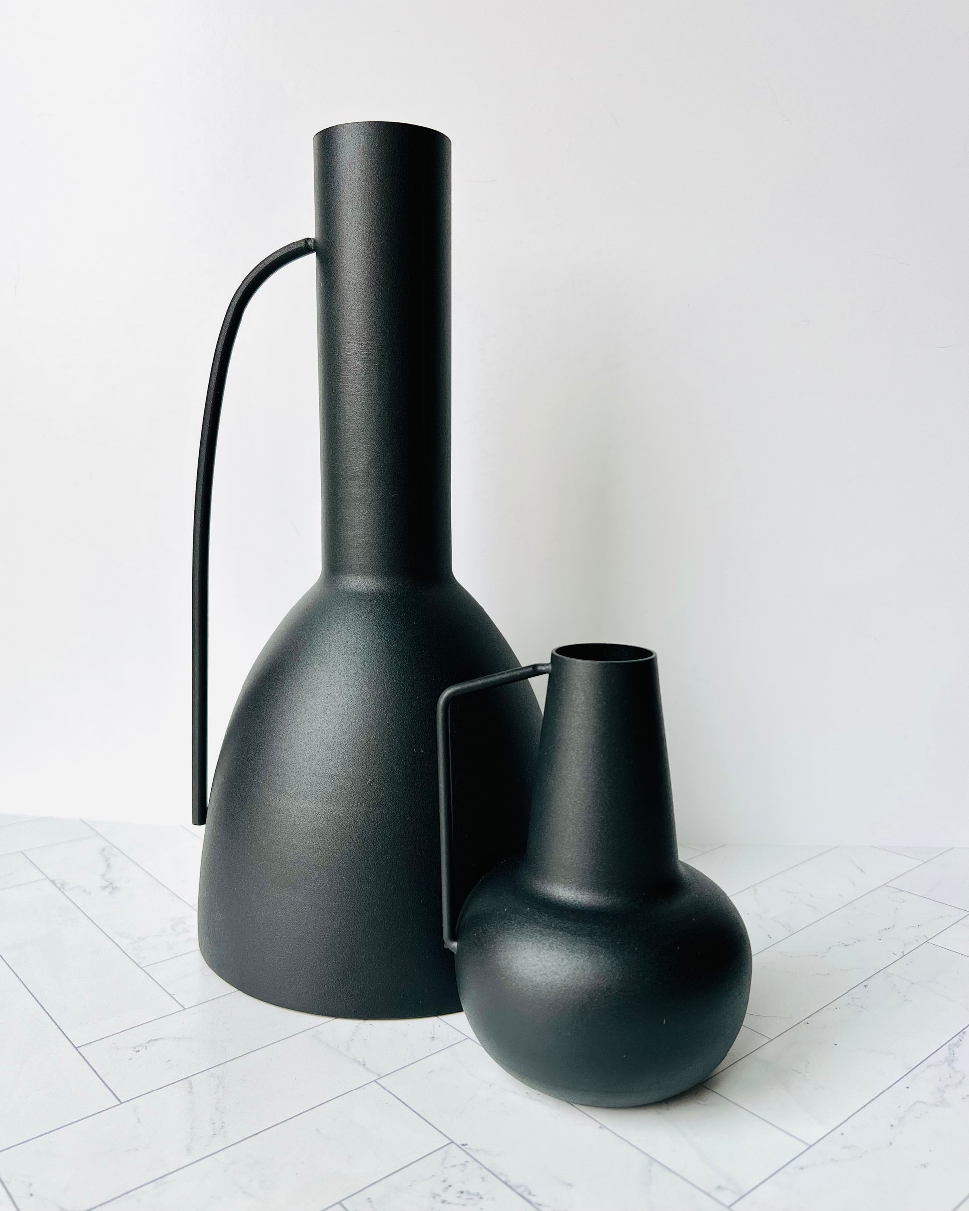 The Sleek Black Vase with its handle out next to the Sleek Bud Vase