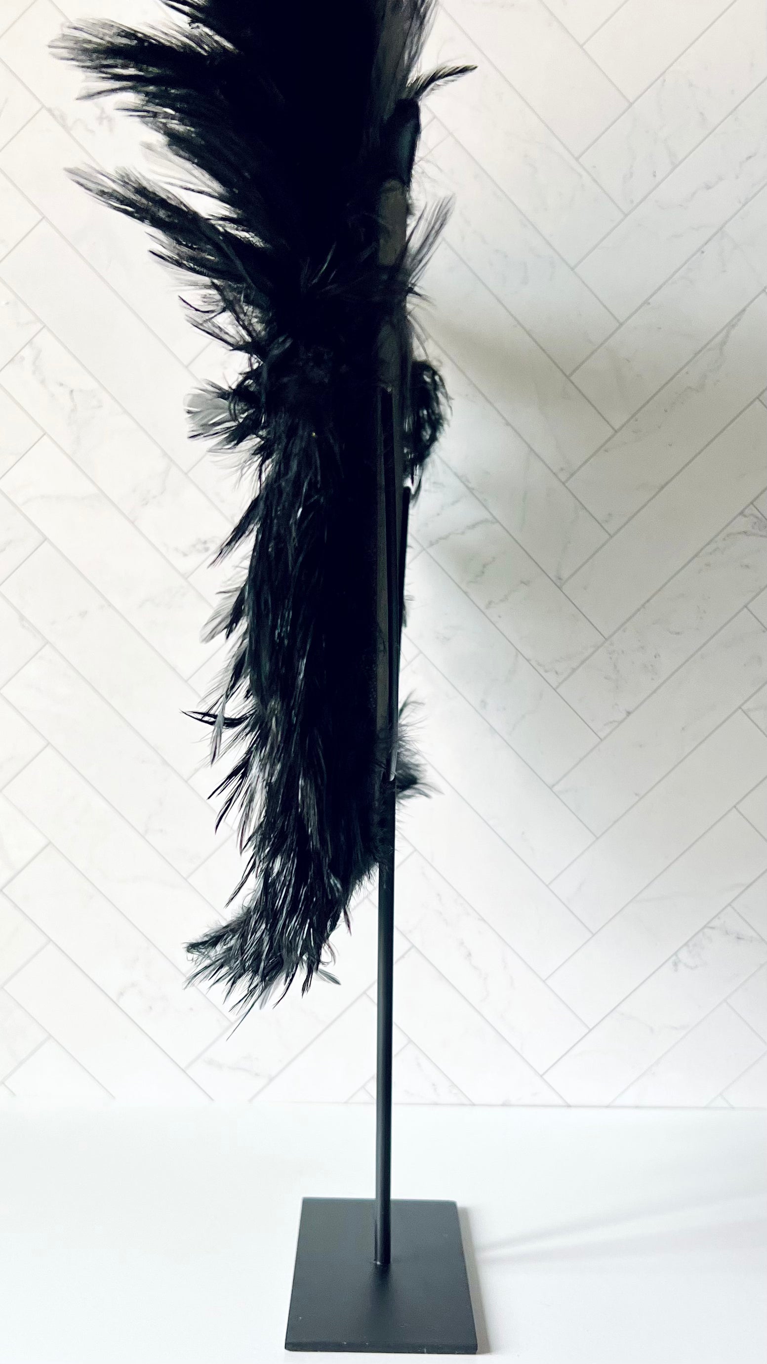 A view from the side of the Standing Black Feathers Decor to show its depth