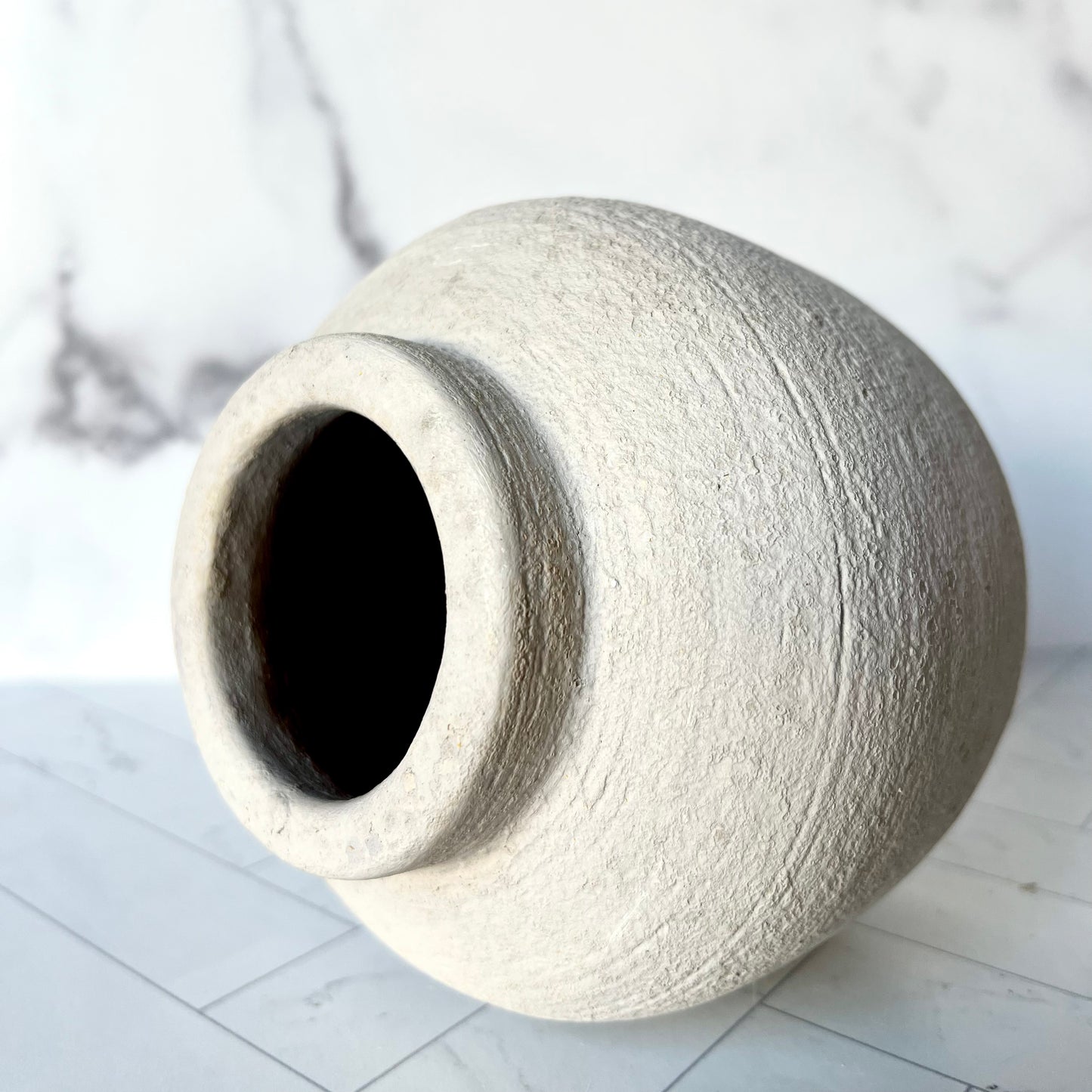 The Petite Concrete Vase shown on its side, revealing the size of the top opening